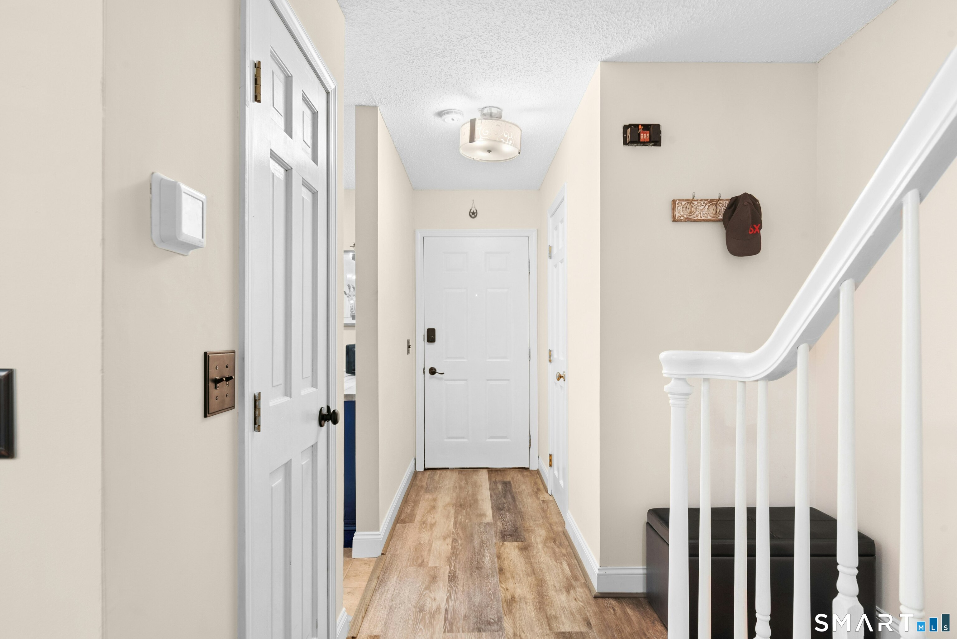 55 Mill Plain Road, Unit 193 Danbury, CT 06811 - Photo 4 of 27 a view of a hallway with wooden floor and staircase