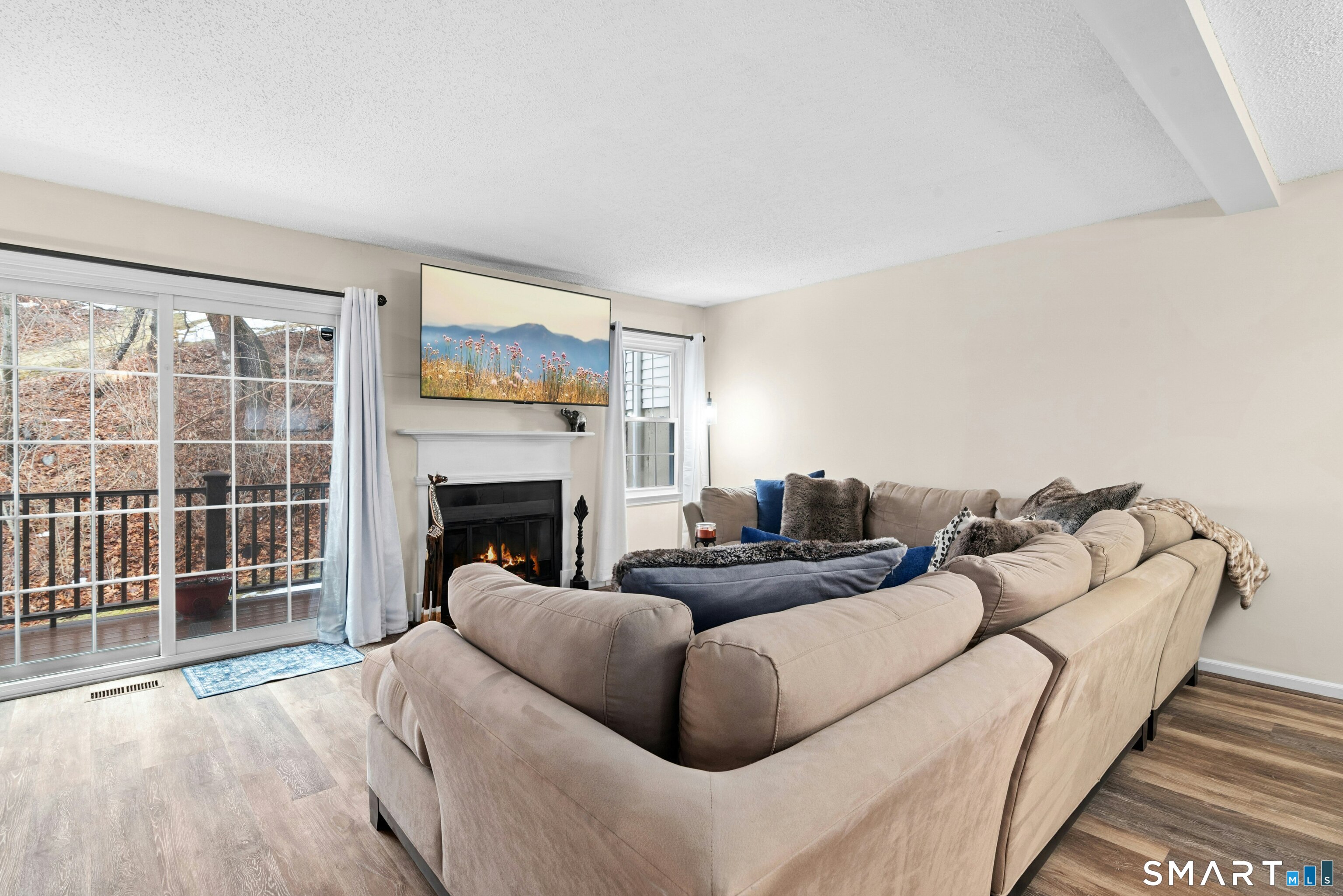 55 Mill Plain Road, Unit 193 Danbury, CT 06811 - Photo 5 of 27 a living room with furniture and a fireplace