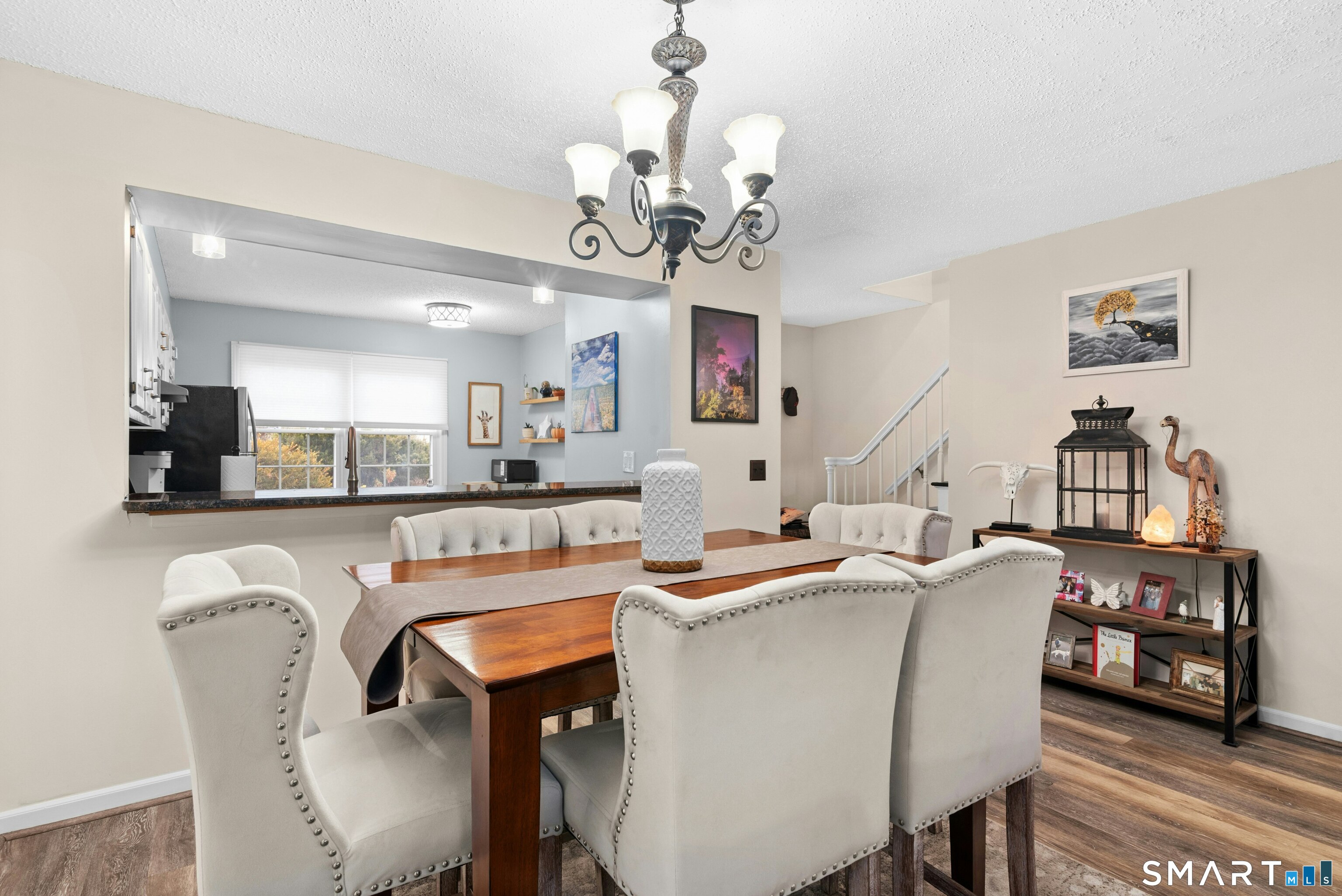 55 Mill Plain Road, Unit 193 Danbury, CT 06811 - Photo 7 of 27 a dining room filled chandelier and wooden floor