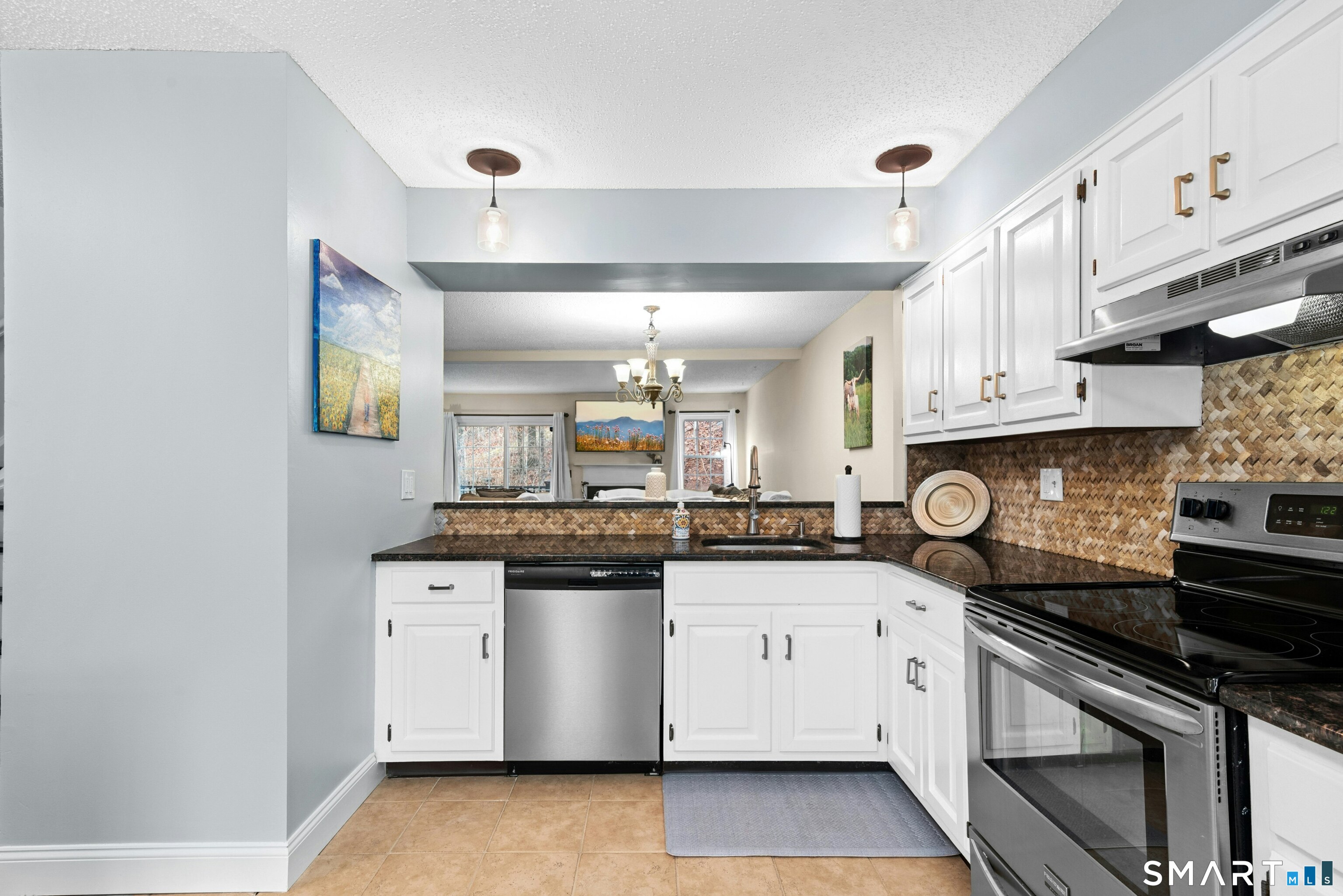 55 Mill Plain Road, Unit 193 Danbury, CT 06811 - Photo 9 of 27 a kitchen with stainless steel appliances granite countertop a sink and cabinets