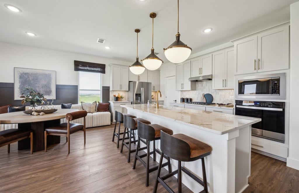 1609 Tyler Drive Anna, TX 75409 - Photo 3 of 18 Spacious kitchen with eat-in bartop island *Model Representation*