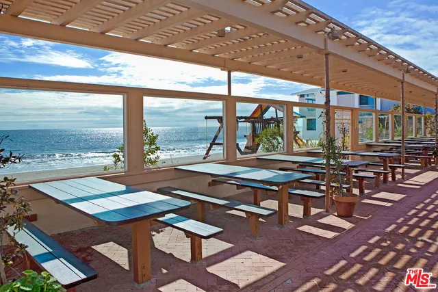 a table and chairs sitting in front of a building