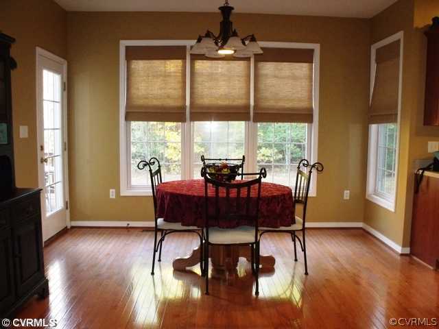 14501 Nash Road Chesterfield, VA 23838 - Photo 8 of 12 a view of a dining room with furniture window and wooden floor
