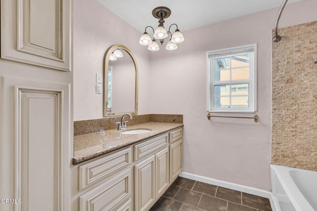 472 Geneva Avenue Claremont, CA 91711 - Photo 29 of 50 a bathroom with a granite countertop sink a mirror and a vanity
