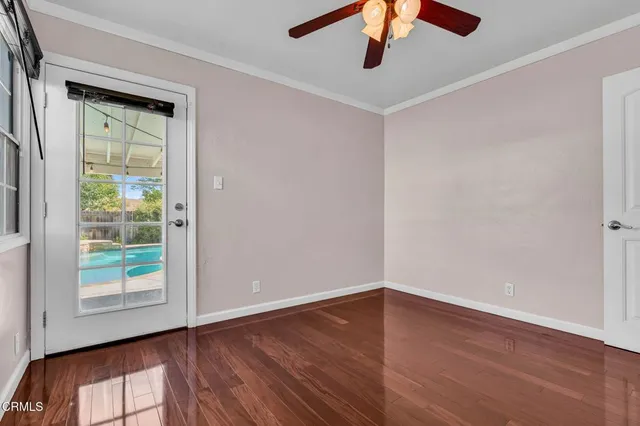wooden floor in an empty room with a window