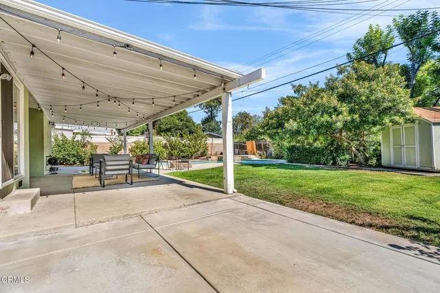 a view of a backyard with porch and garden