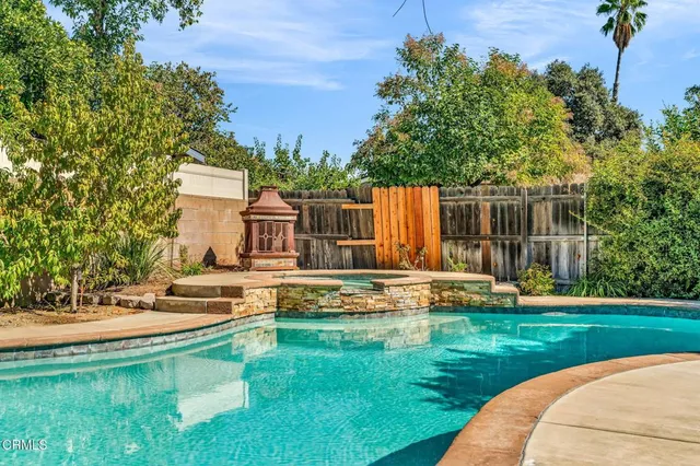 a view of a house with swimming pool and a yard