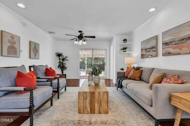 a living room with furniture and a potted plant