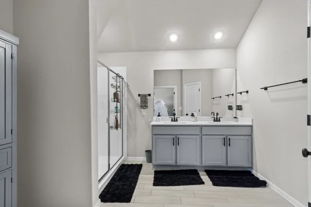a kitchen with a sink a refrigerator and cabinets