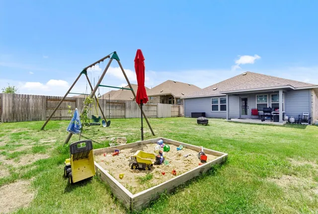a view of a house with a yard and deck