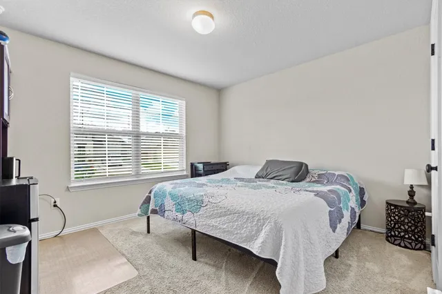 a bedroom with a bed and a table in it