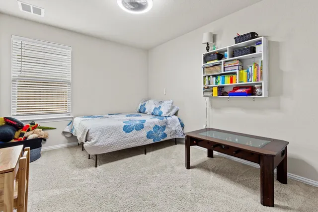 a bedroom with furniture and a bed