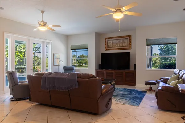 a bedroom with a bed and large windows