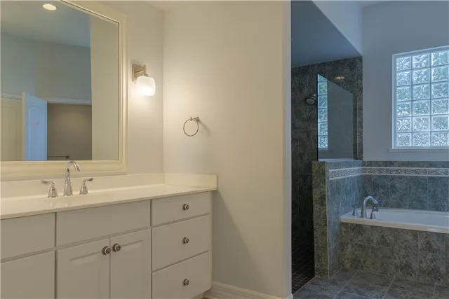 a bathroom with a bathtub and shower