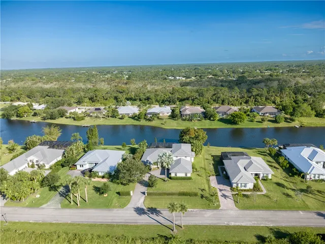 an aerial view of a house with a ocean view