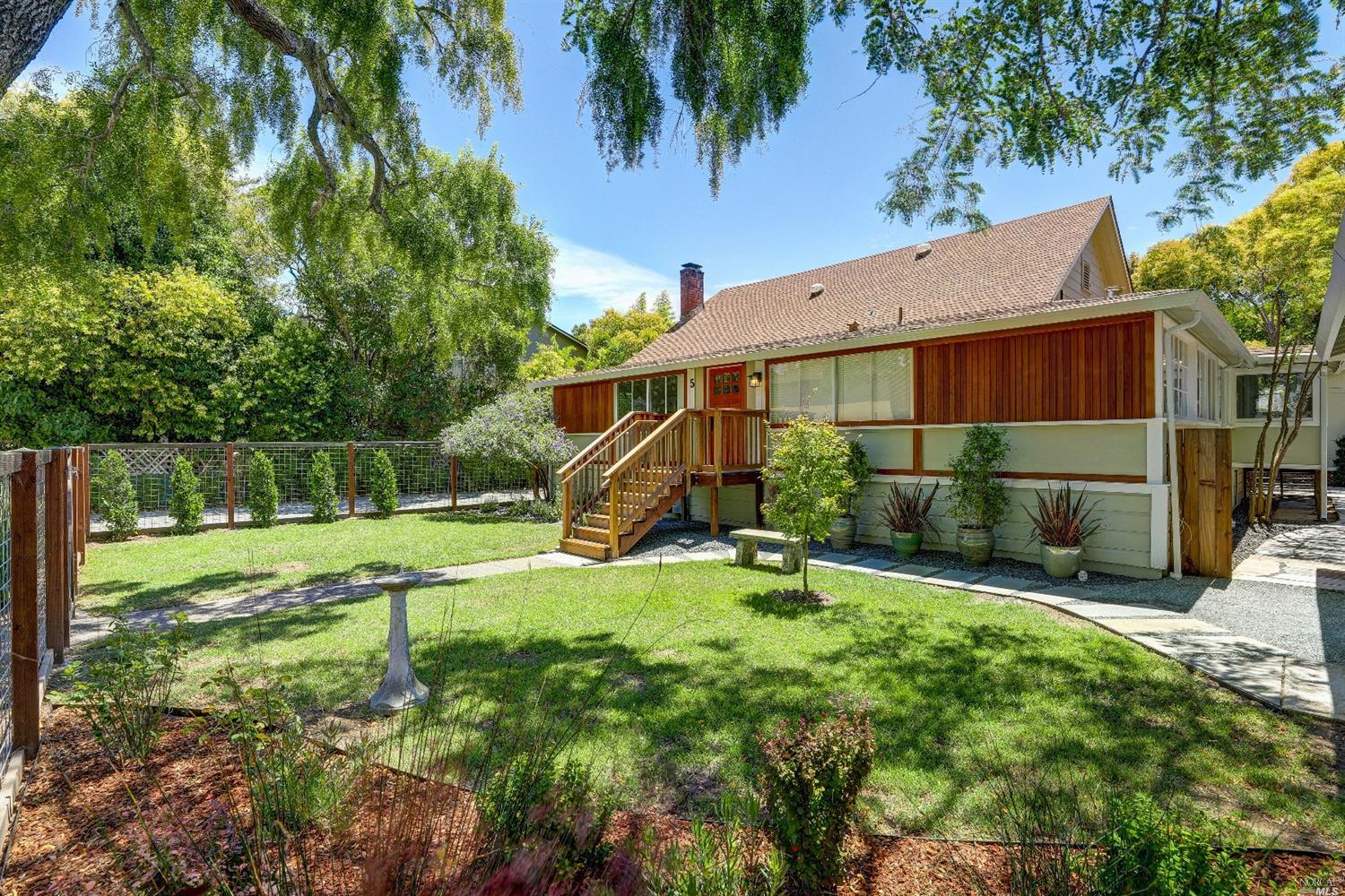 a view of a house with backyard and sitting area