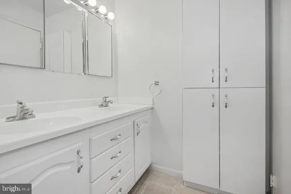a bathroom with a double vanity sink and mirror