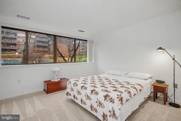 a bedroom with a bed lamp and window