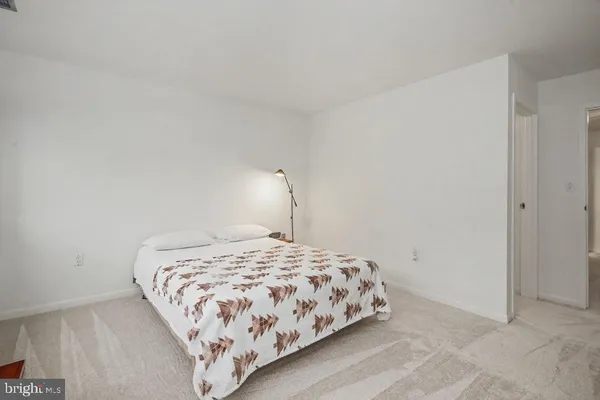 a bedroom with a bed and a lamp