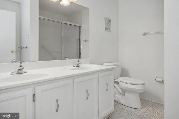 a bathroom with a sink toilet and a mirror