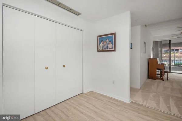 a view of a livingroom with wooden floor and furniture