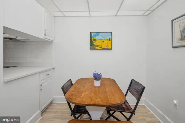 a view of a dining room with a table and chairs