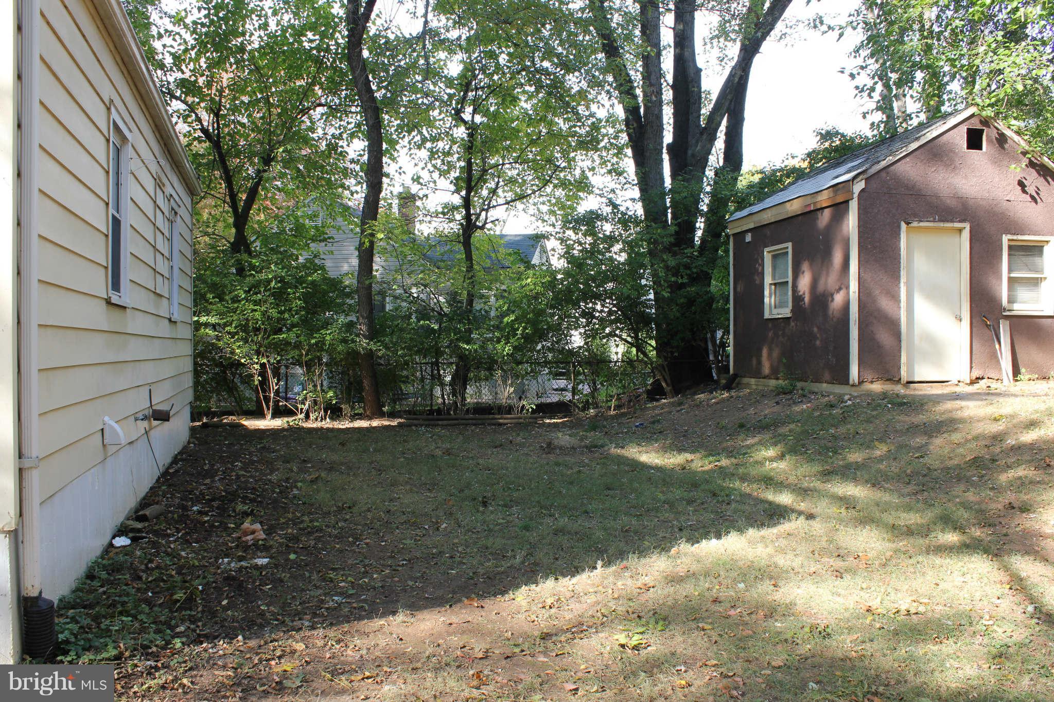 12107 Dewey Road Silver Spring, MD 20906 - Photo 3 of 30 a backyard of a house with lots of green space