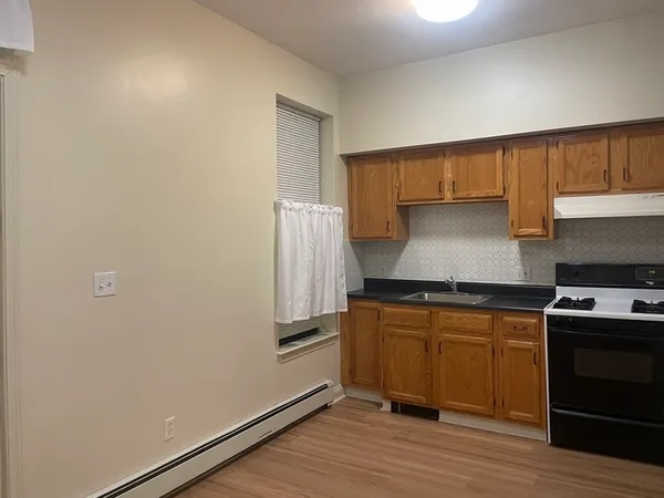 a kitchen with a stove and a refrigerator
