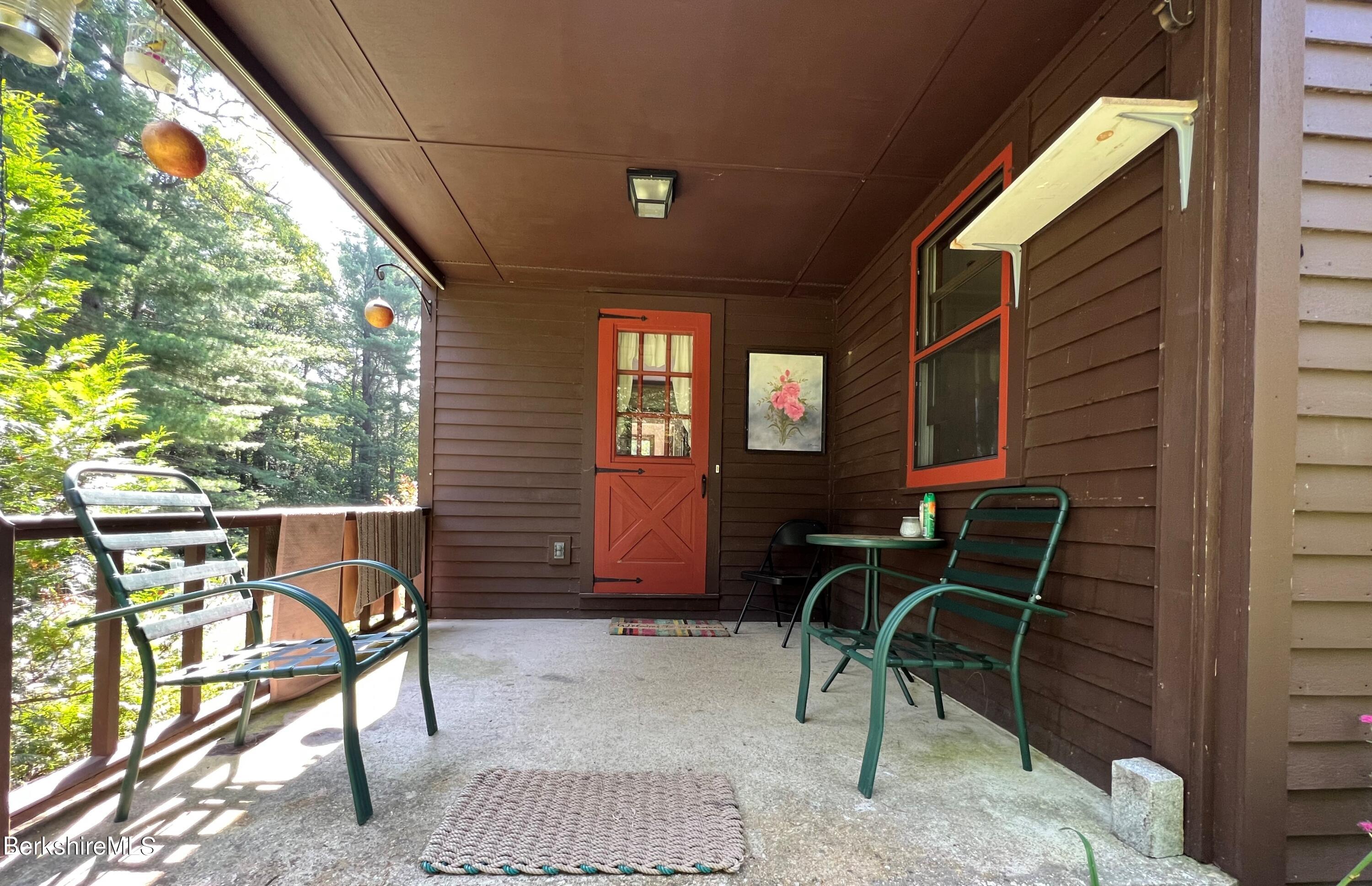 280 Middlefield Road Washington, MA 01223 - Photo 6 of 28 a view of a porch with furniture and a yard
