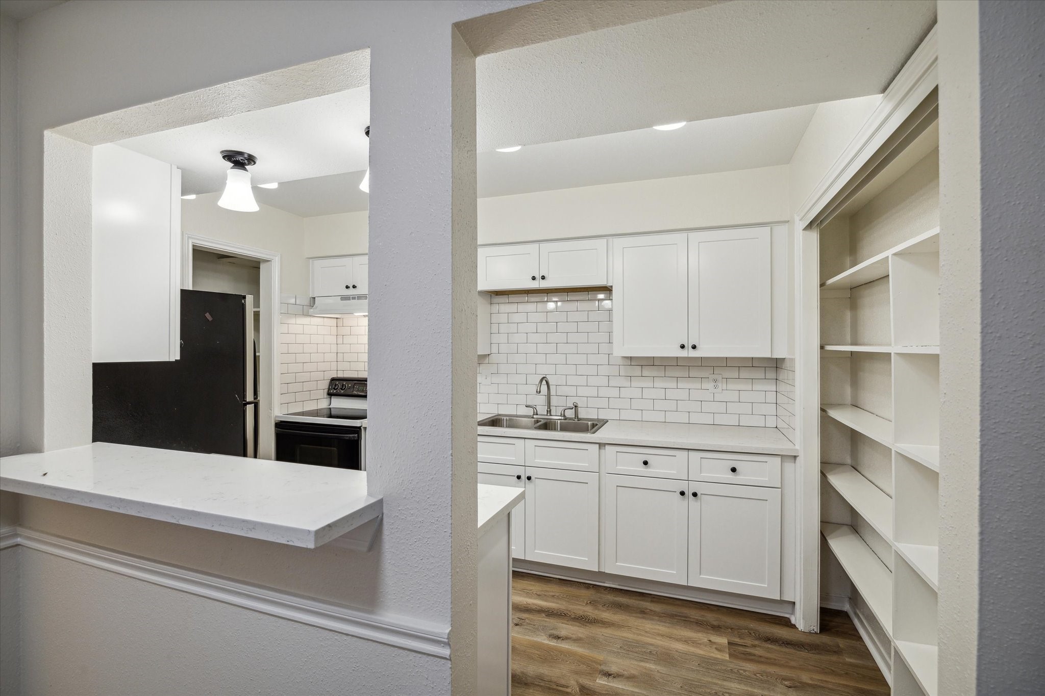 11540 Chimney Rock Road, Unit 128 Houston, TX 77035 - Photo 5 of 14 a kitchen with white cabinets and sink