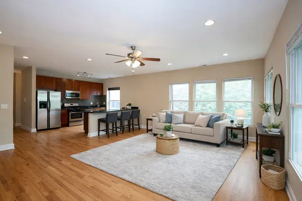 a living room with lots of furniture and kitchen view