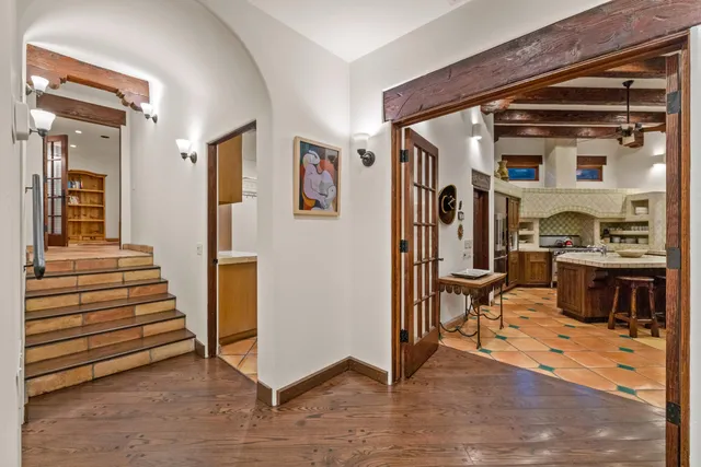 a living room with furniture a rug and a bookshelf