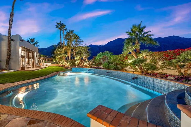 a view of a swimming pool with a table and chairs