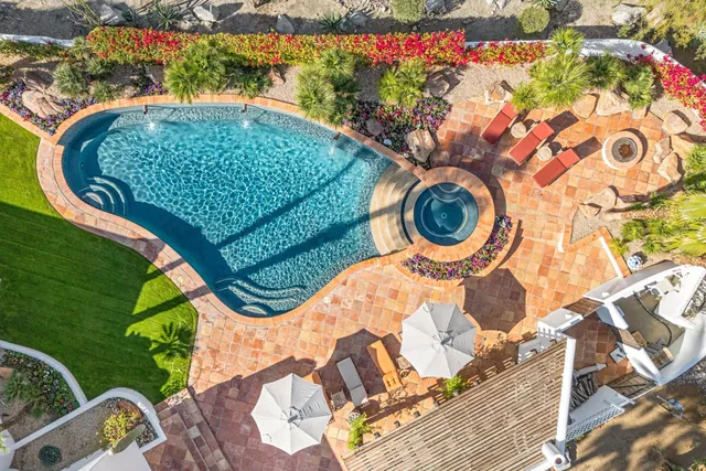 a view of a dining room with furniture and a chandelier