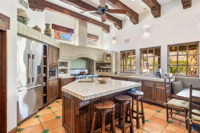 a kitchen with a table chairs stove and refrigerator