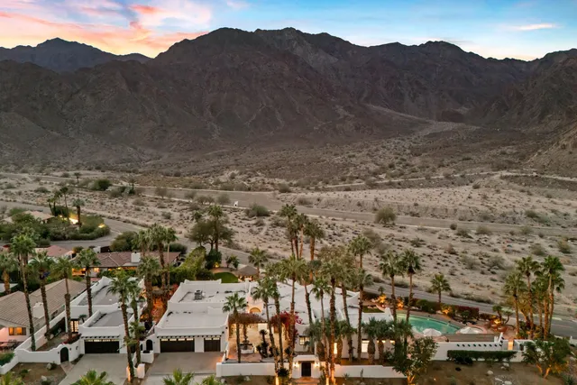a view of a house with a tree in front