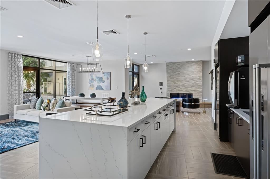 775 Juniper Street Northeast, Unit 309 Atlanta, GA 30308 - Photo 30 of 49 a kitchen with stainless steel appliances a sink stove and refrigerator