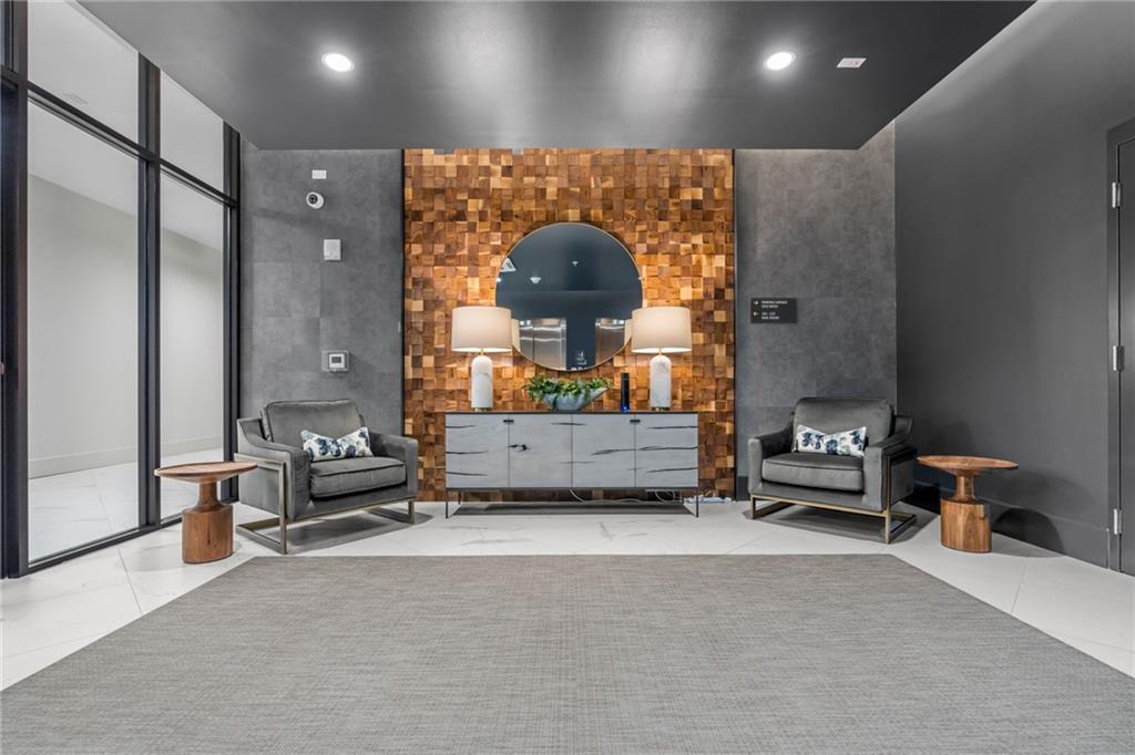 775 Juniper Street Northeast, Unit 309 Atlanta, GA 30308 - Photo 42 of 49 a living room with furniture and a mirror