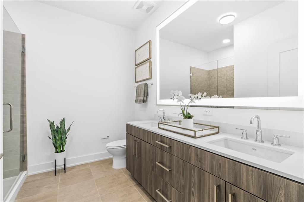 775 Juniper Street Northeast, Unit 309 Atlanta, GA 30308 - Photo 6 of 49 a bathroom with a double vanity sink and a toilet