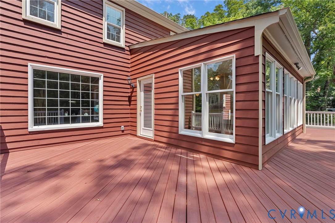 8707 Brown Summit Road North Chesterfield, VA 23235 - Photo 5 of 72 Expansive deck with red-stained wood flooring.