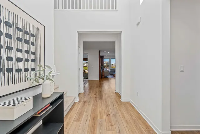 a view of hallway with wooden floor