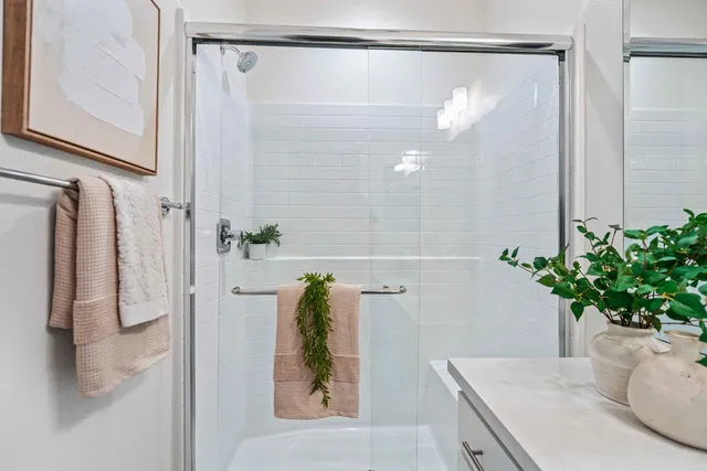 a bathroom with a shower curtain and a mirror