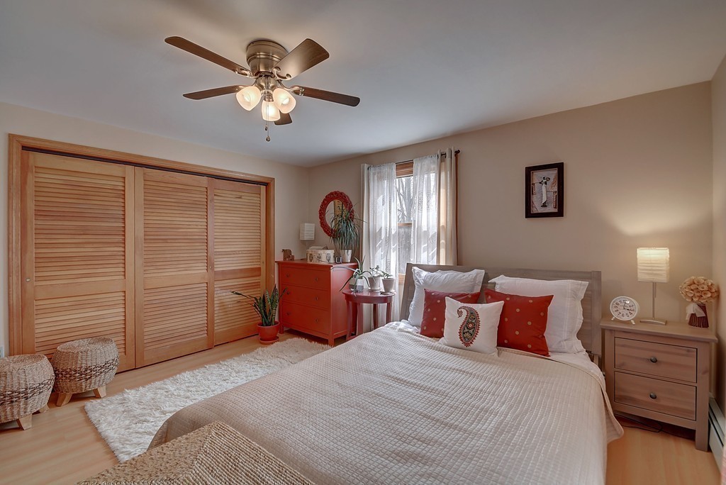 95 B Mason Road Dudley, MA 01571 - Photo 19 of 30 a bedroom with a large bed and a chandelier