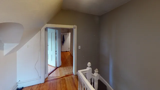 a view of an entryway with wooden floor