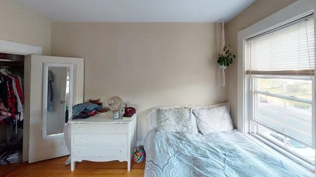 a bedroom with a bed and a window