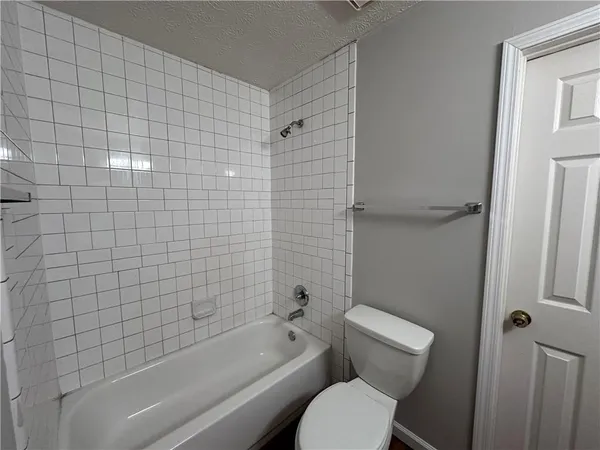 a bathroom with a toilet bathtub and shower