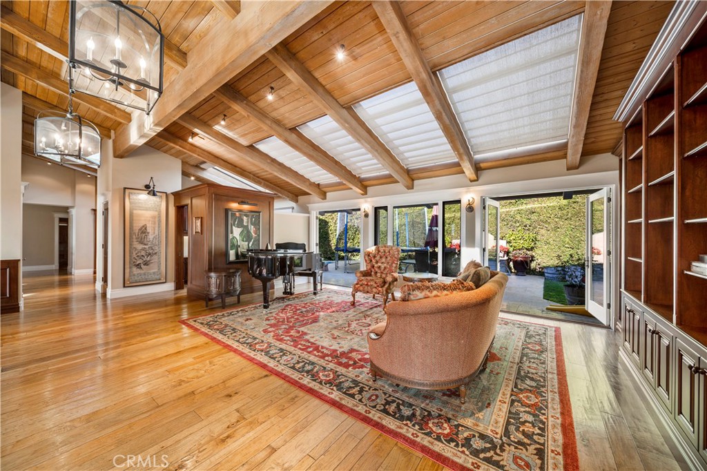 822 Emerald Bay Laguna Beach, CA 92651 - Photo 11 of 26 a living room with furniture a wooden floor and next to a window