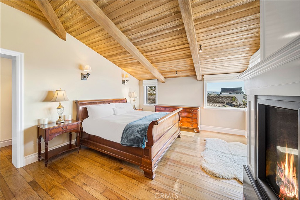 822 Emerald Bay Laguna Beach, CA 92651 - Photo 14 of 26 a spacious bedroom with a bed and a flat screen tv