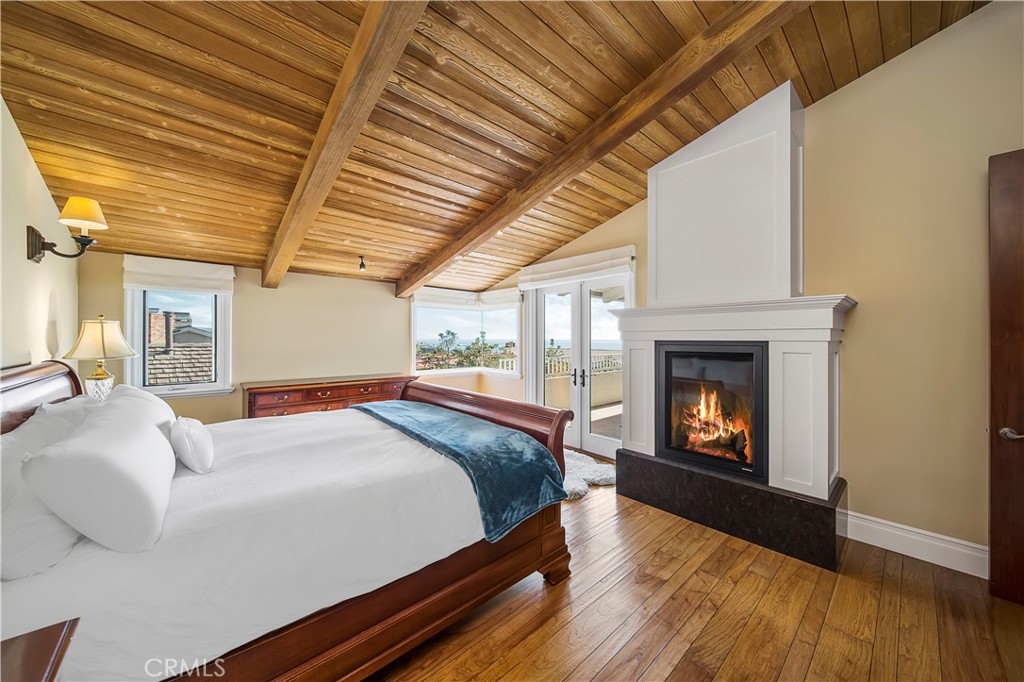 822 Emerald Bay Laguna Beach, CA 92651 - Photo 15 of 26 a bedroom with a bed and a fireplace