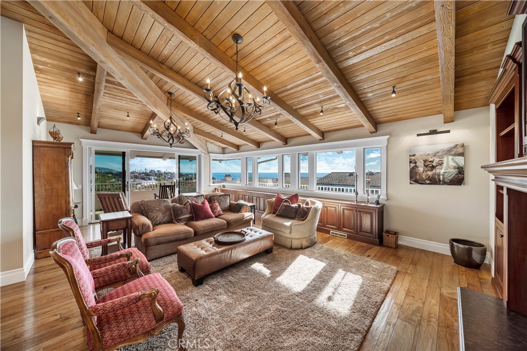 822 Emerald Bay Laguna Beach, CA 92651 - Photo 9 of 26 a living room with furniture ceiling fan and a rug